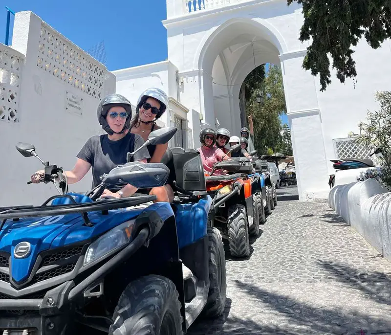 Group of riders in helmets ready to start a Santorini ATV tour