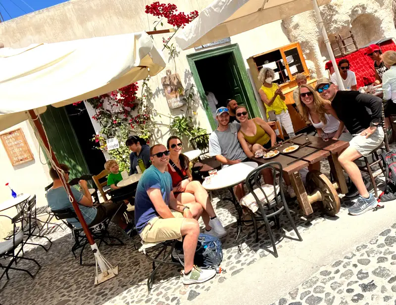 Riders relaxing at a traditional cafe wine stop on a Santorini ATV tour